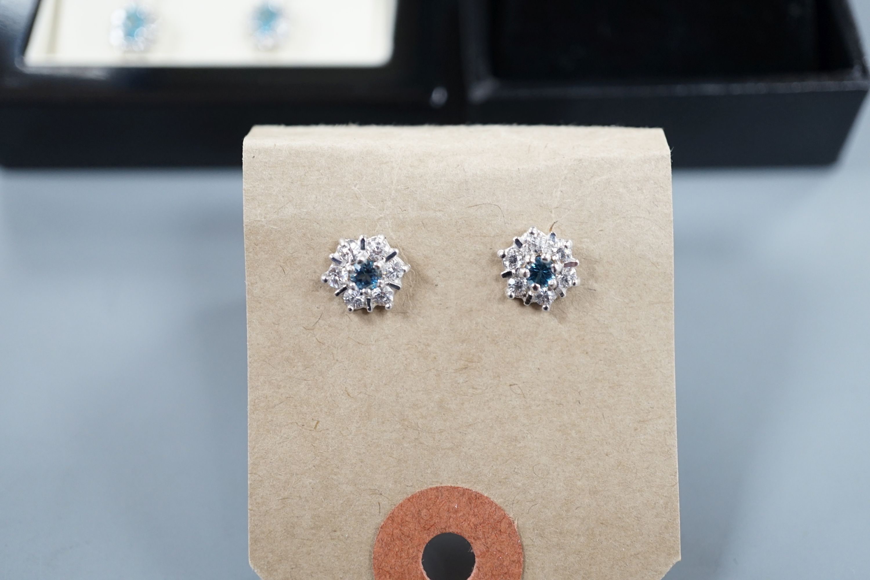 Three assorted modern pairs of gem set earrings, two white metal stamped 375 and one pair stamped 925.